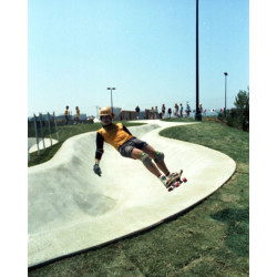 Skateboarders with Helmets and Knee Pads at the Skate Park