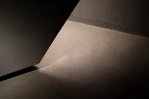 Light and shadow in the corner of gray interior concrete building, 2021