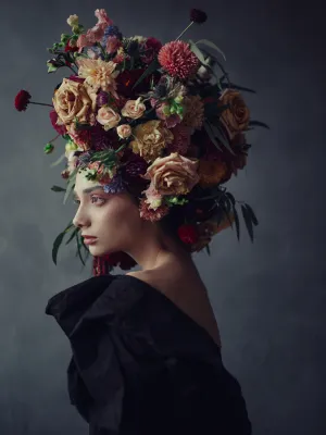 Thoughtful young woman in floral headdress, 2019