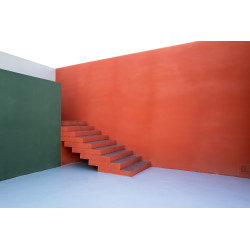 Ladder in the corner of a colored building