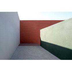 Corridor composed of colored concrete walls, with sunlight effect